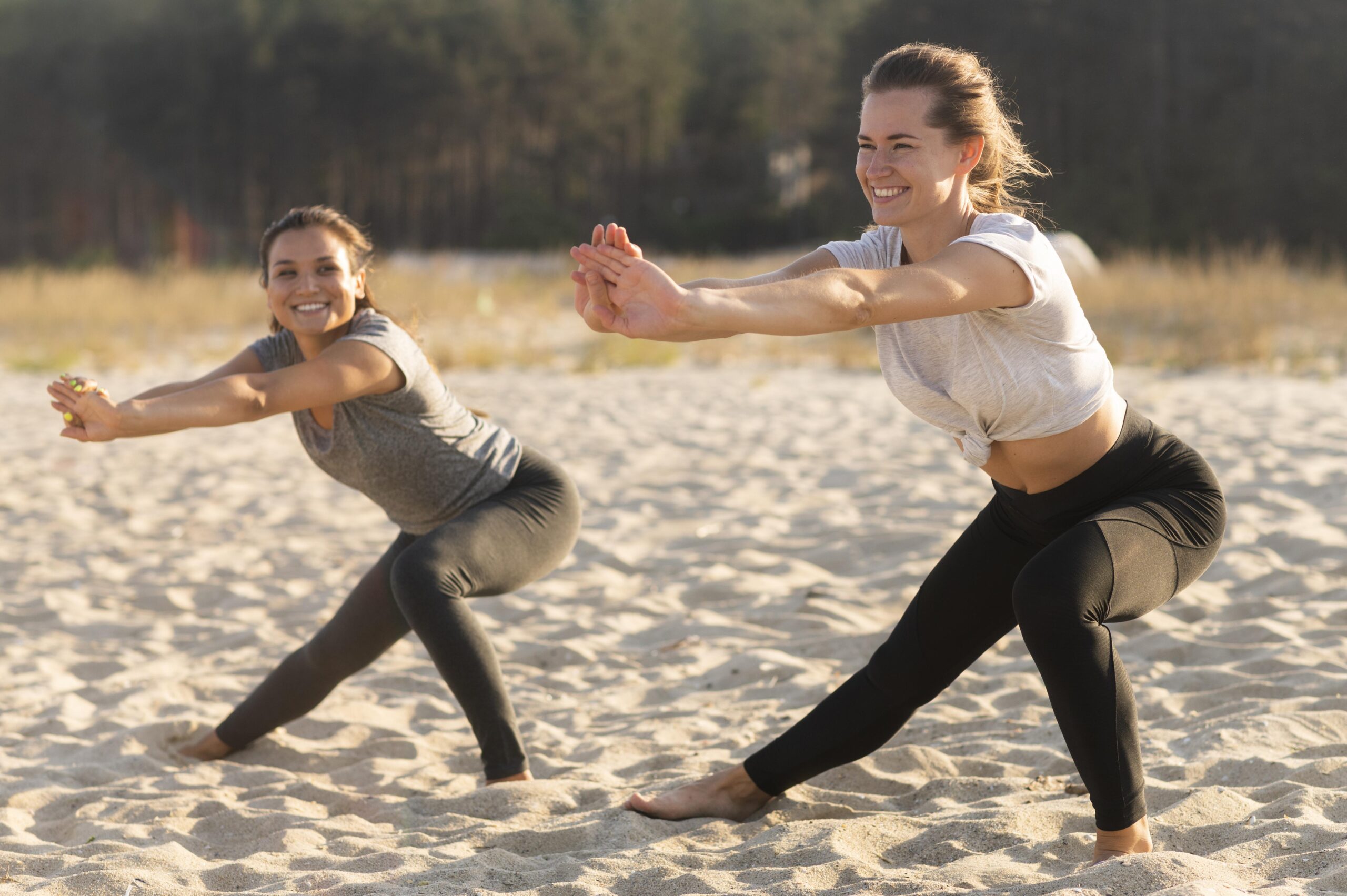 smiley-female-friends-exercising-beach